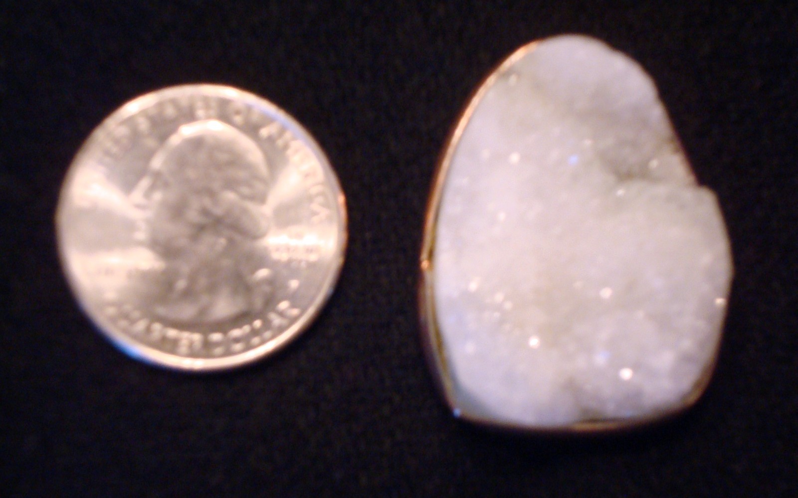 Quartz crystals, includes a white geode crystal slice in a metal setting