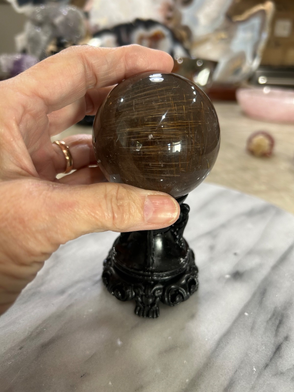 Smoky quartz rutile sphere on resin stand 2.47”