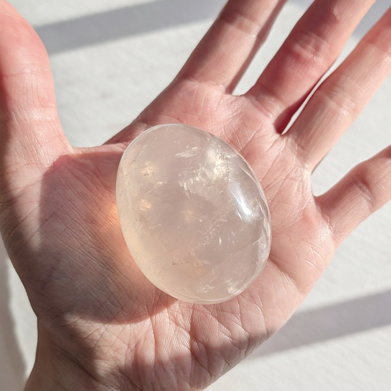 2″ translucent rose quartz palmstone with rainbow and asterism, star rose quartz