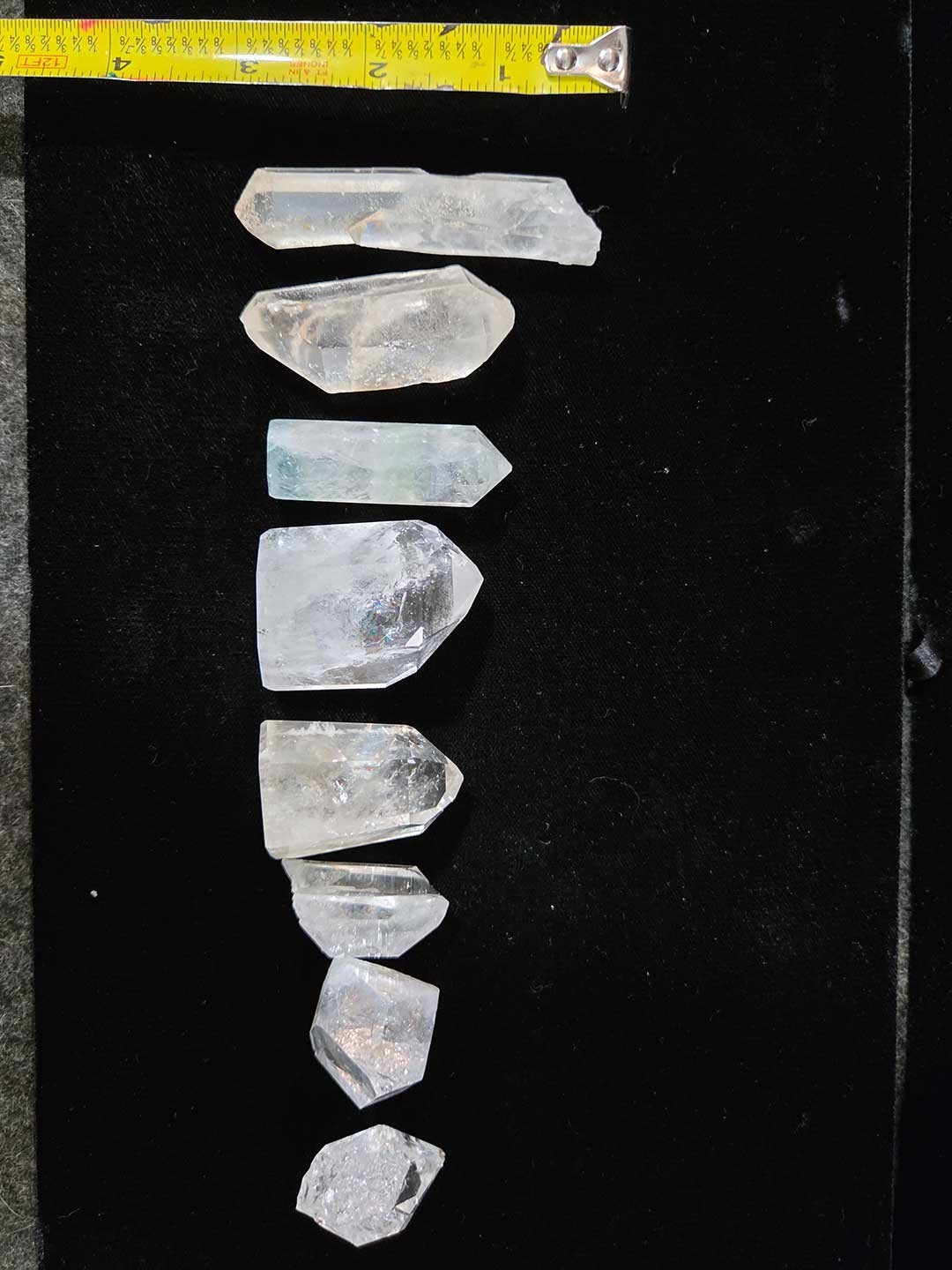 Collection of 9 clear quartz crystal points, 1in. to 3in.