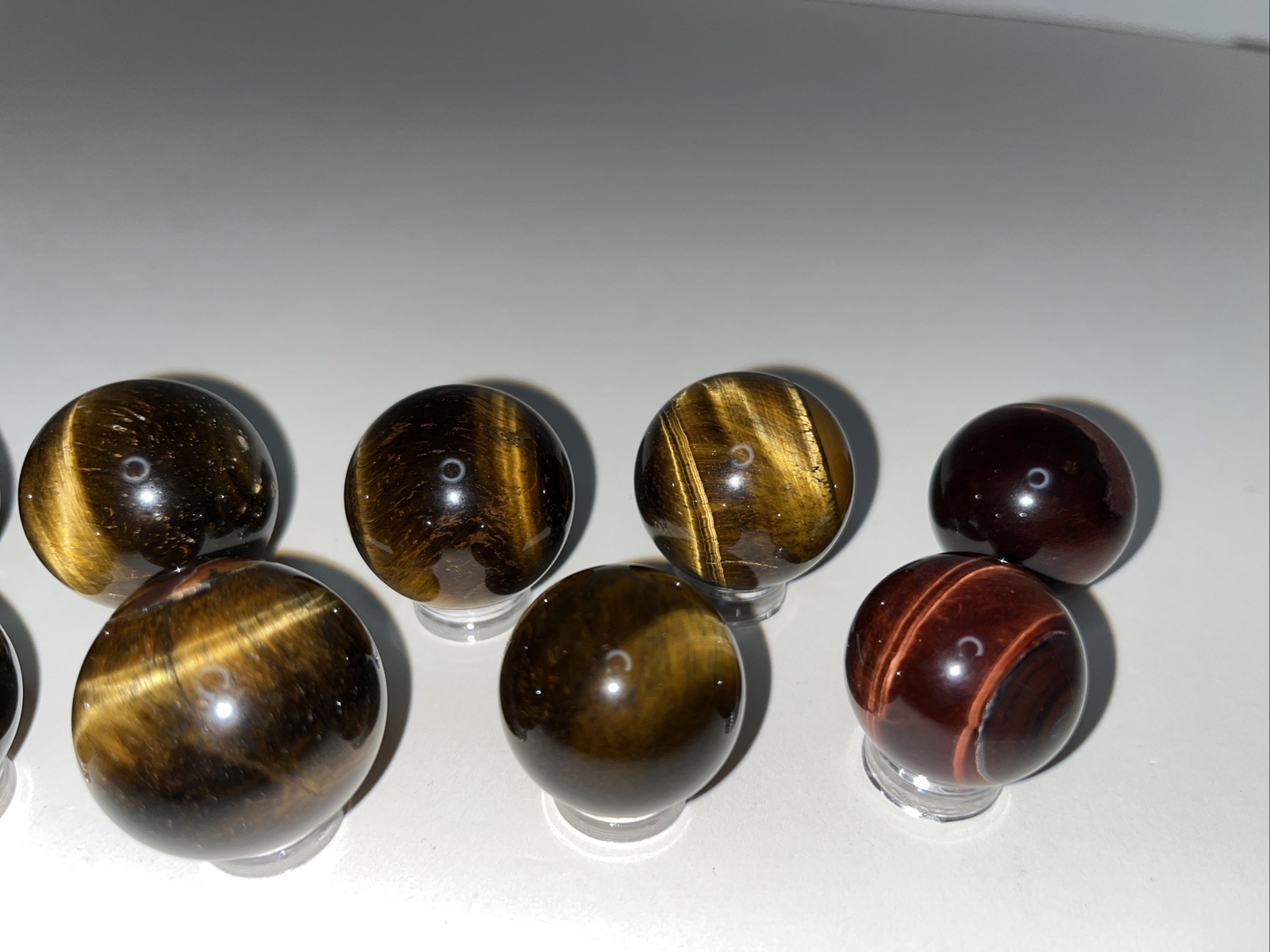 Sphere lot/tigers eye with acrylic stands.