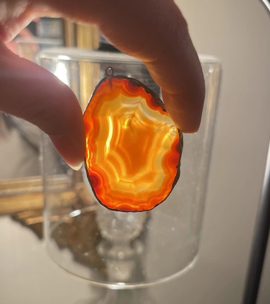 Polished slice of a natural agate geode, likely Brazilian or Botswana Pendant