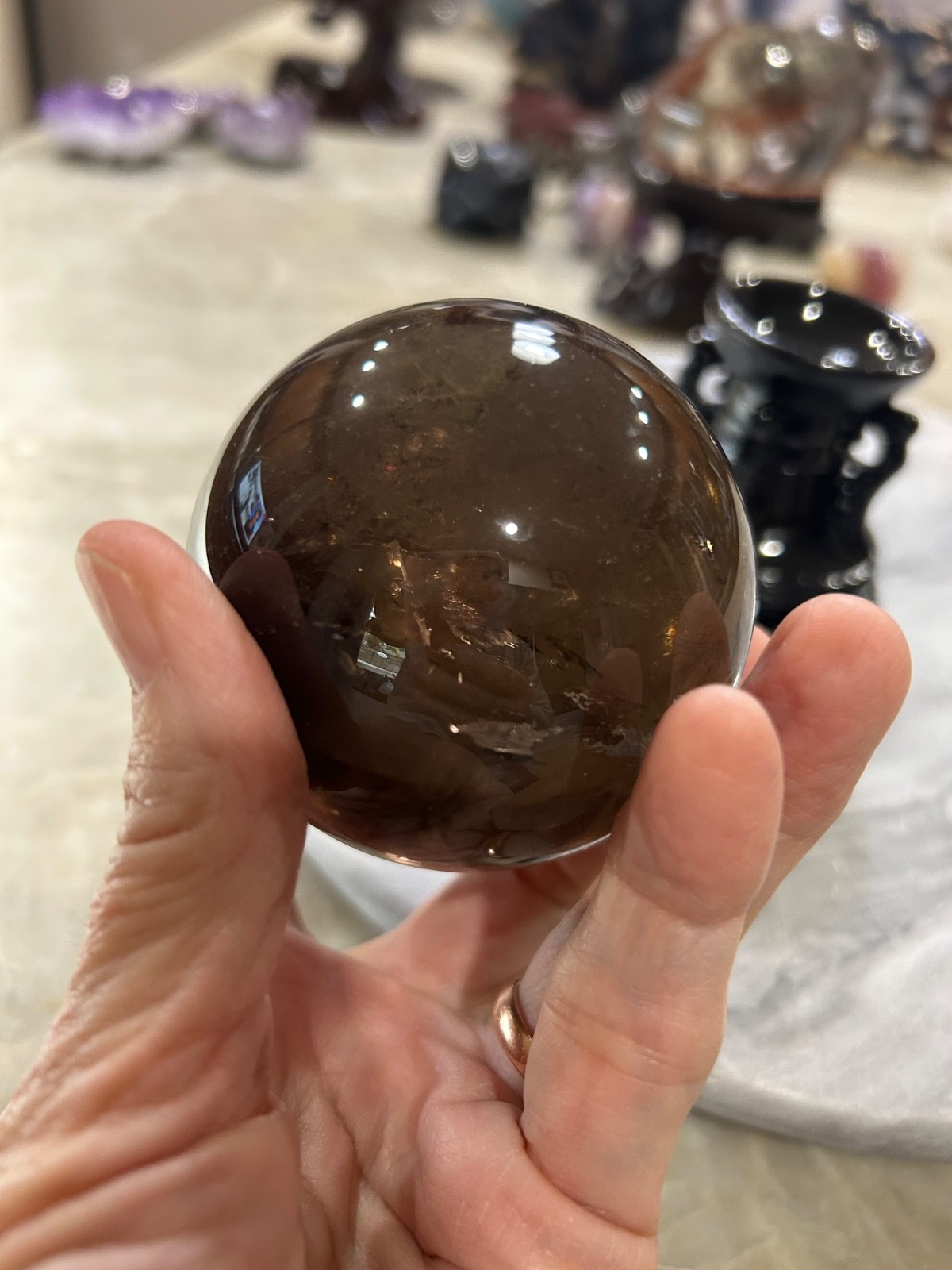 Smoky quartz sphere on resin stand 2.72”