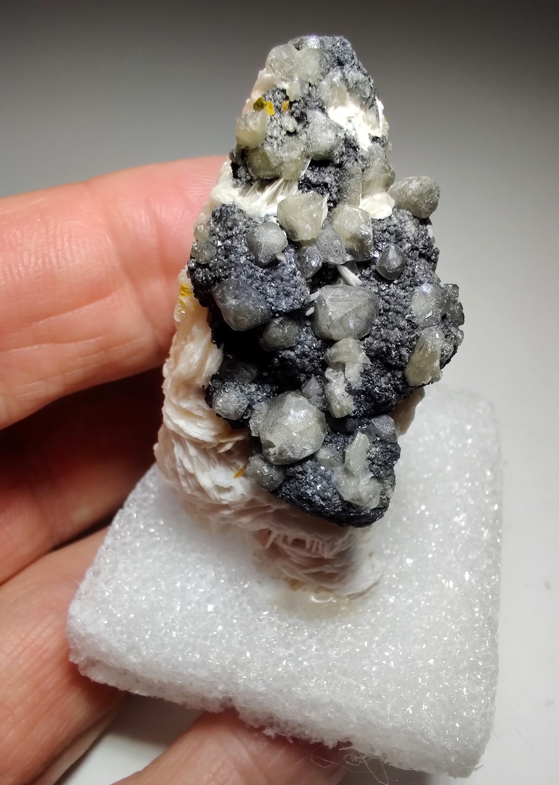 Wulfenite, Cerussite and Barite crystals, UV. Mibladen, Morocco. 6 cm.