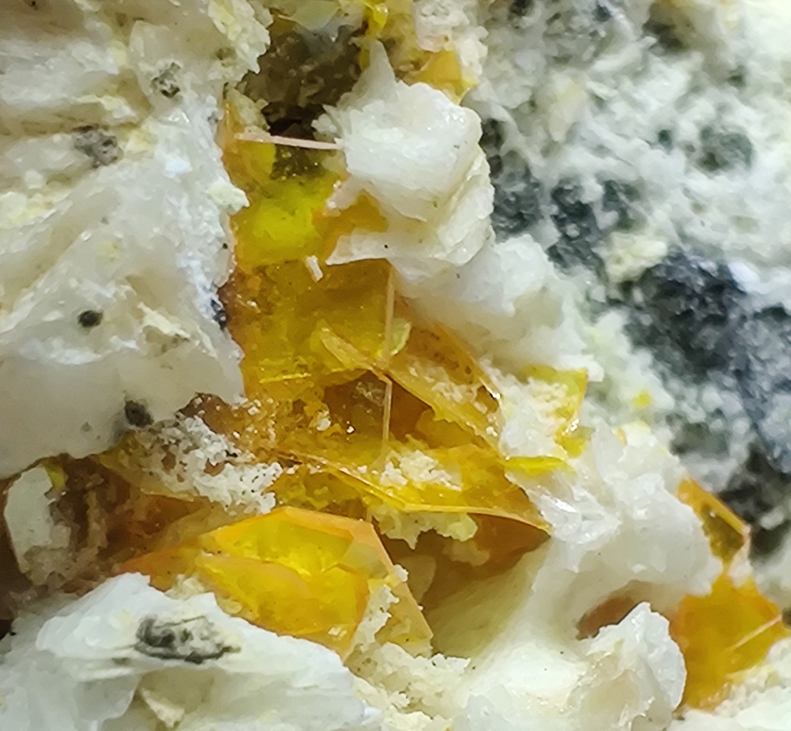 Wulfenite, Cerussite and Barite crystals, UV. Mibladen, Morocco. 6 cm.