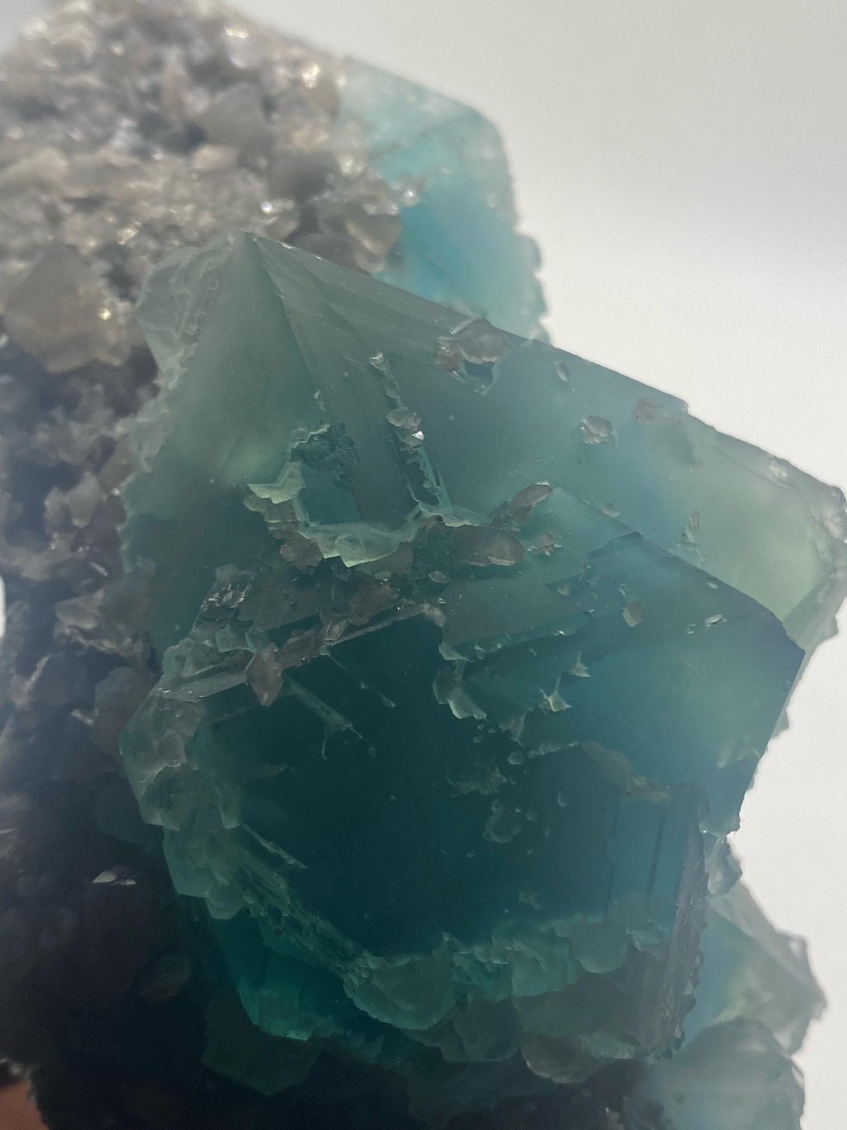 Teal Fluorite Octahedron Cluster on Smoky Quartz