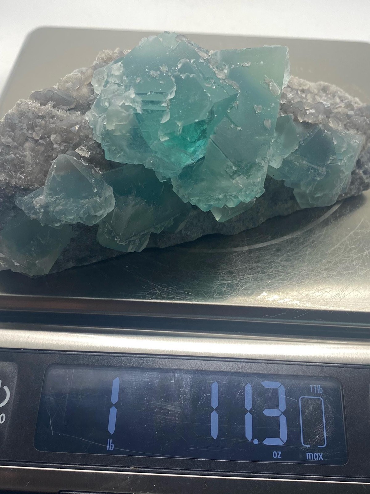 Teal Fluorite Octahedron Cluster on Smoky Quartz