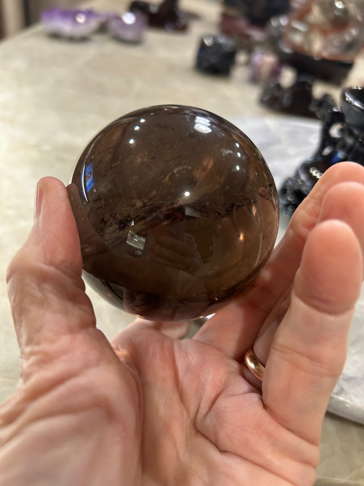 Smoky quartz sphere on resin stand 2.72”