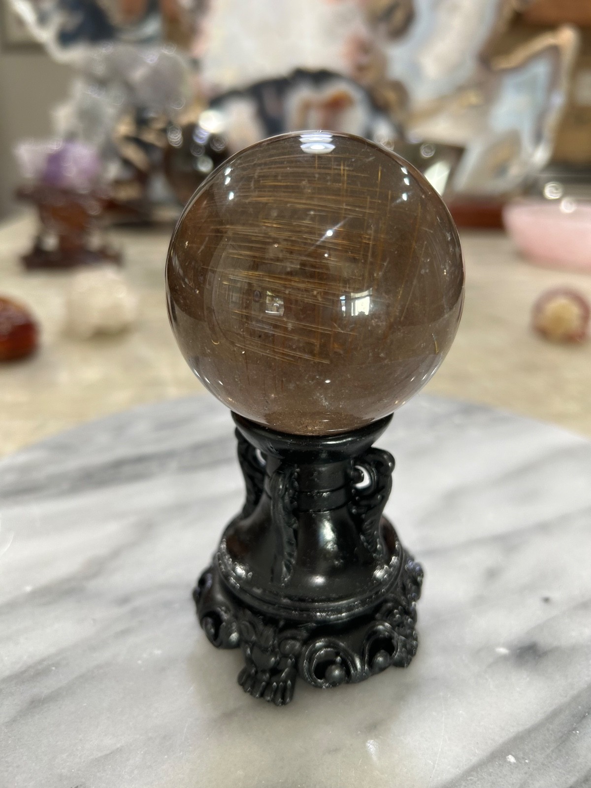 Smoky quartz rutile sphere on resin stand 2.47”