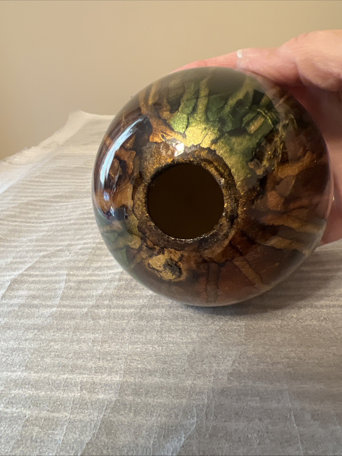 ceramic gazing ball paperweight with a colorful finish.