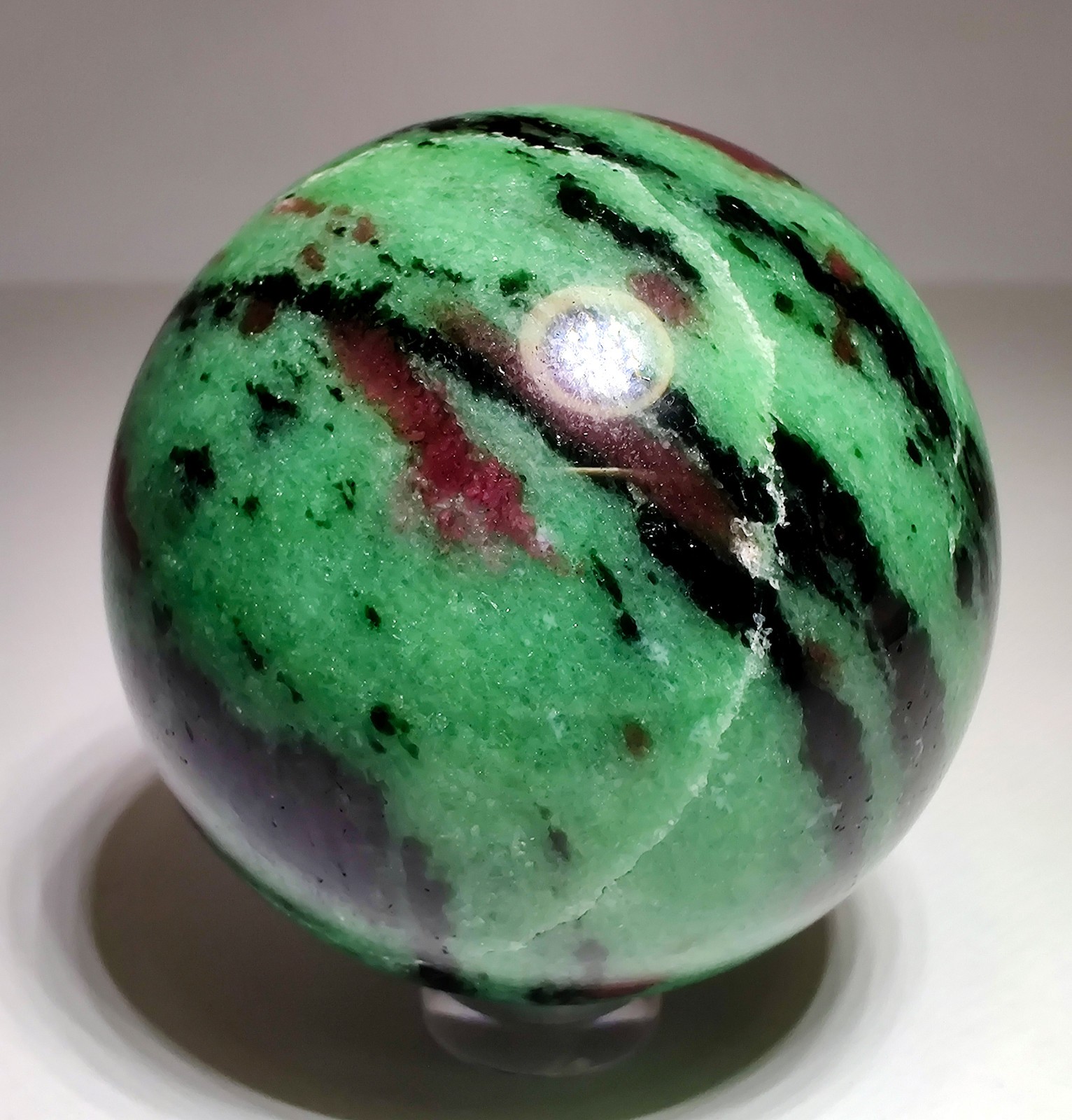 Ruby in Zoisite polished sphere, fluorescent. Tanzania. 238 grams.