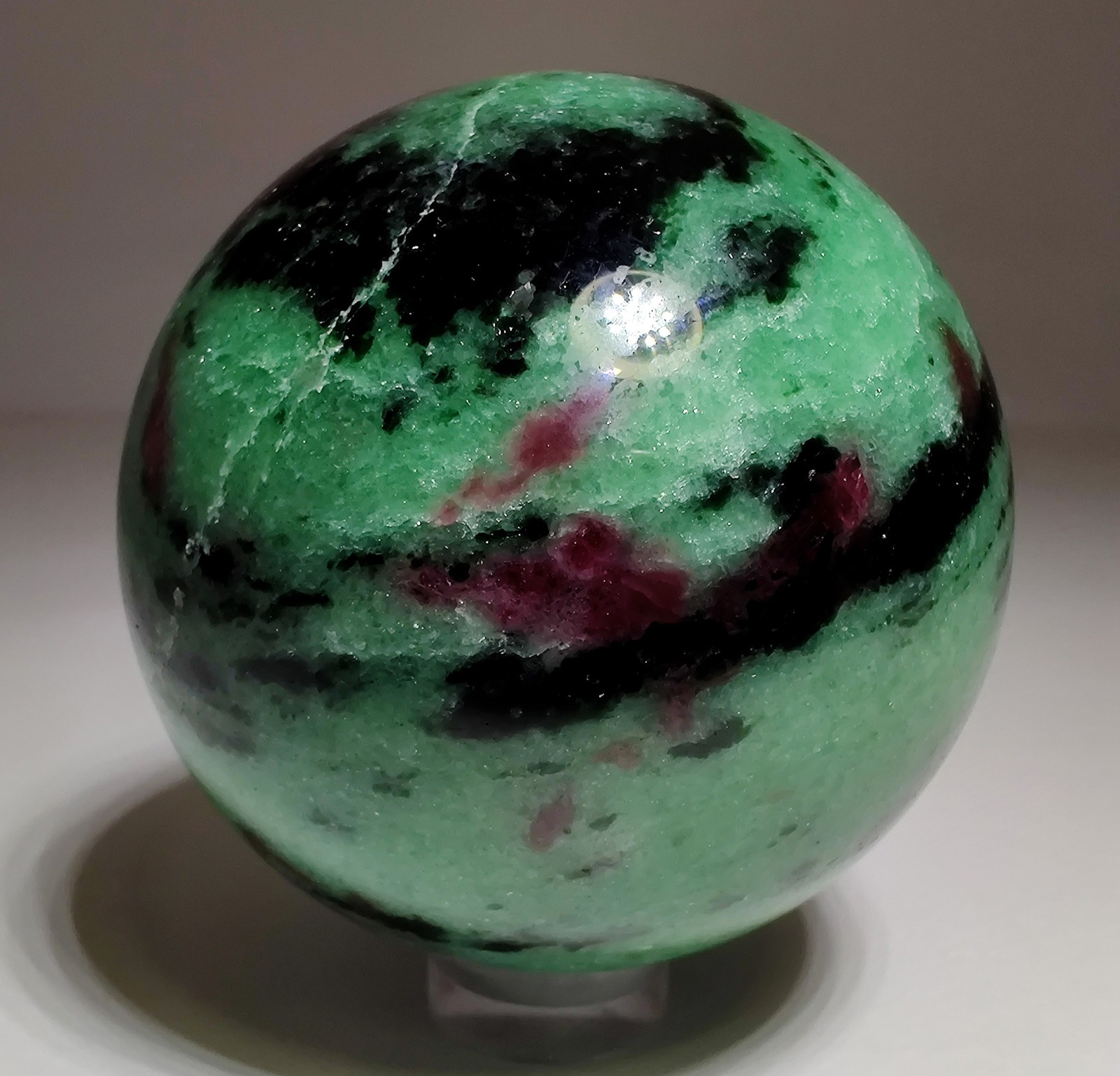 Ruby in Zoisite polished sphere, fluorescent. Tanzania. 238 grams.
