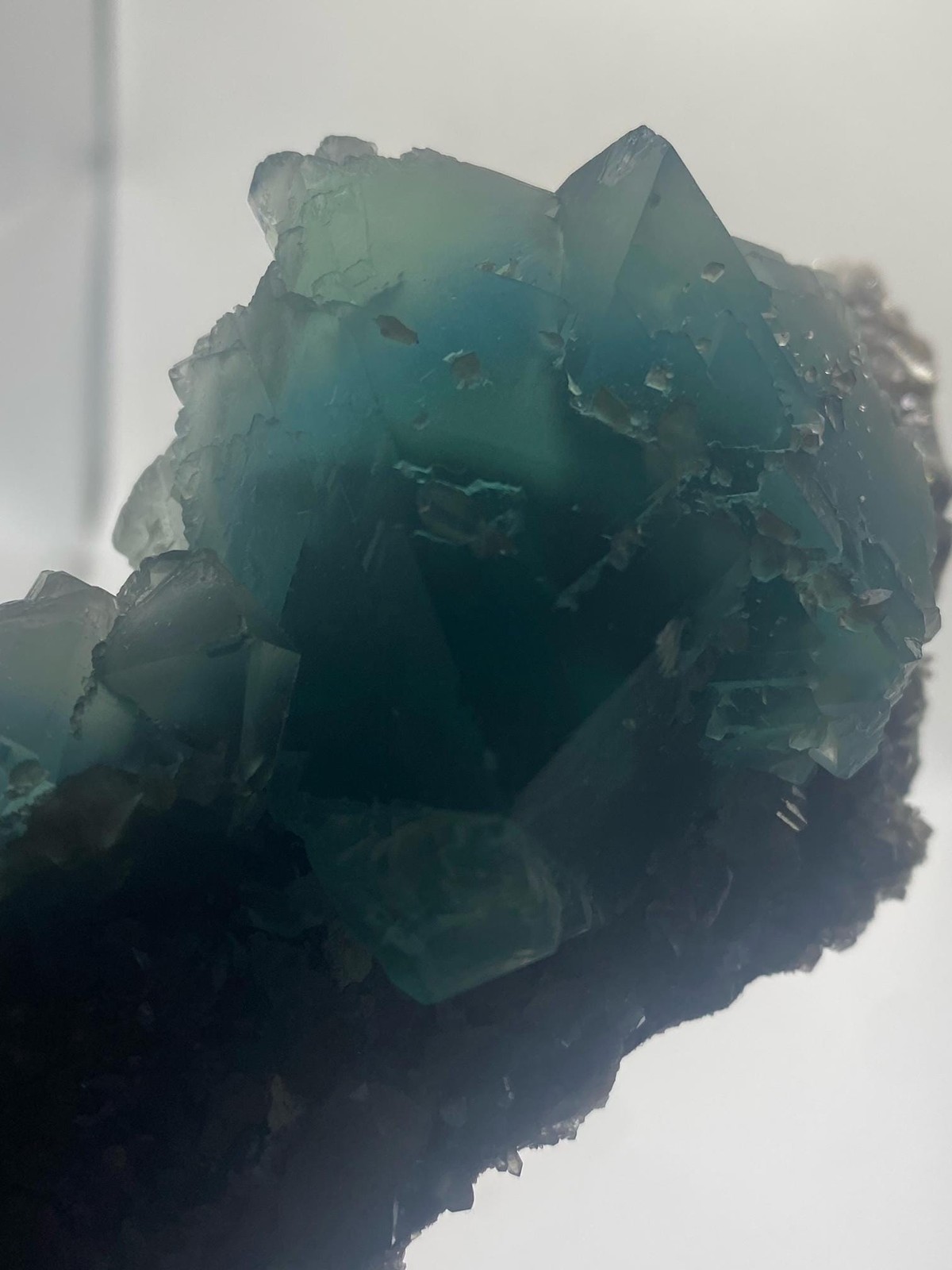Teal Fluorite Octahedron Cluster on Smoky Quartz
