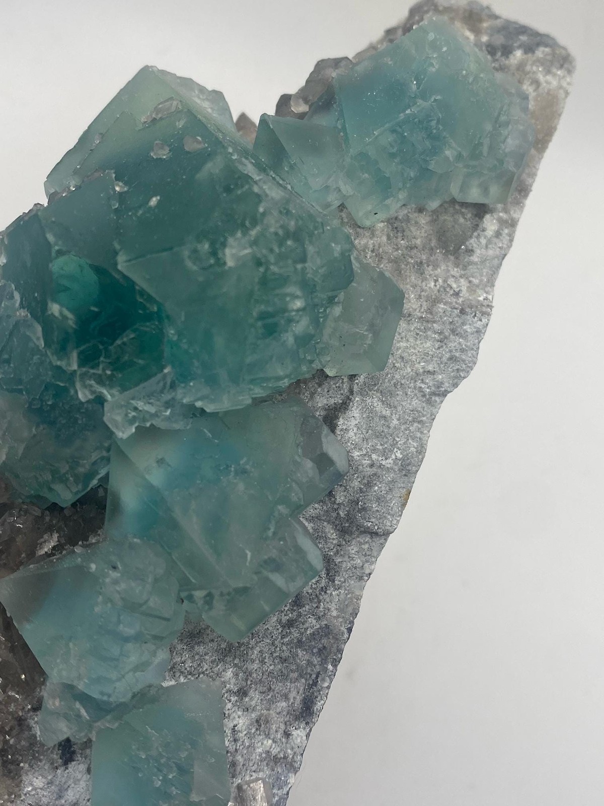 Teal Fluorite Octahedron Cluster on Smoky Quartz