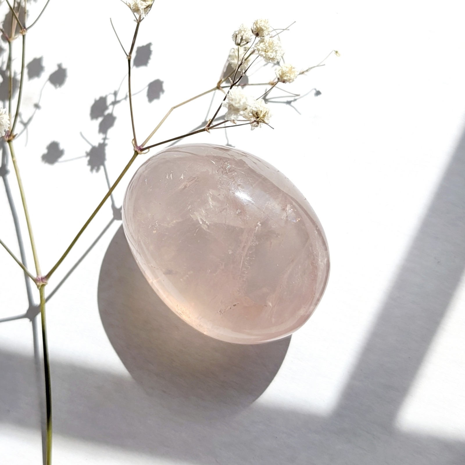 2″ translucent rose quartz palmstone with rainbow and asterism, star rose quartz