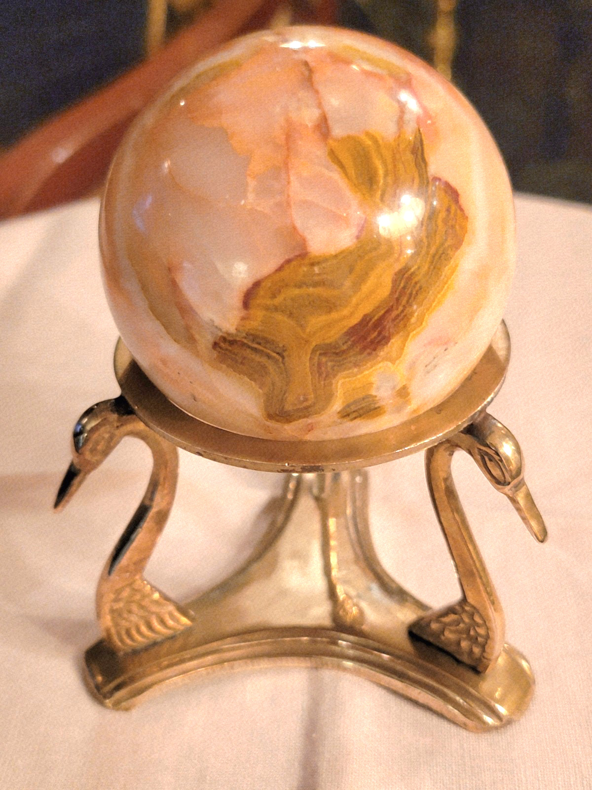 BEAUTIFUL RHODOCHROSITE SPHERE WITH POLISHED BRASS SWAN-HEADS STAND, 5’’