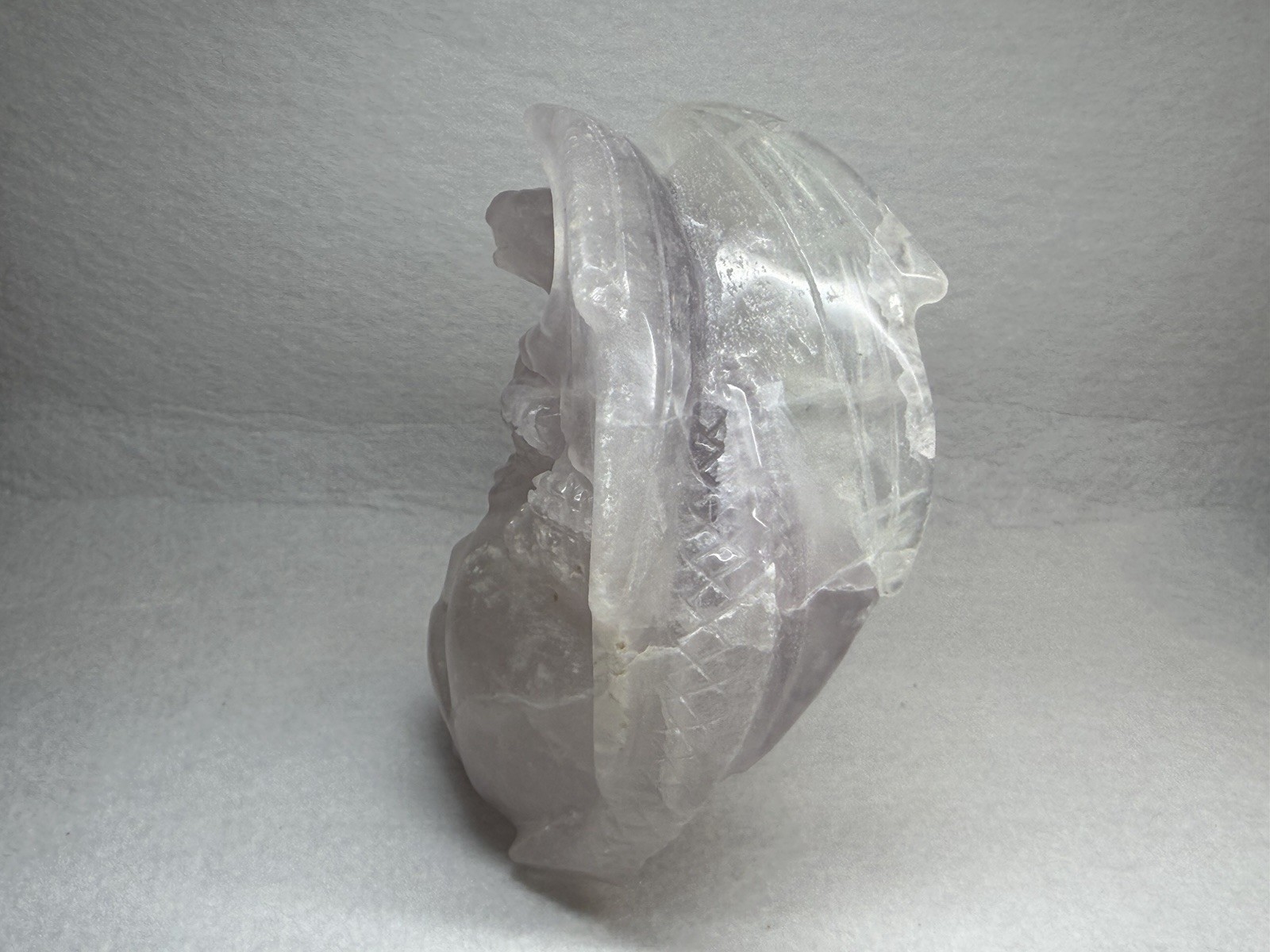 Hand-carved fluorite dragon perched on a human skull