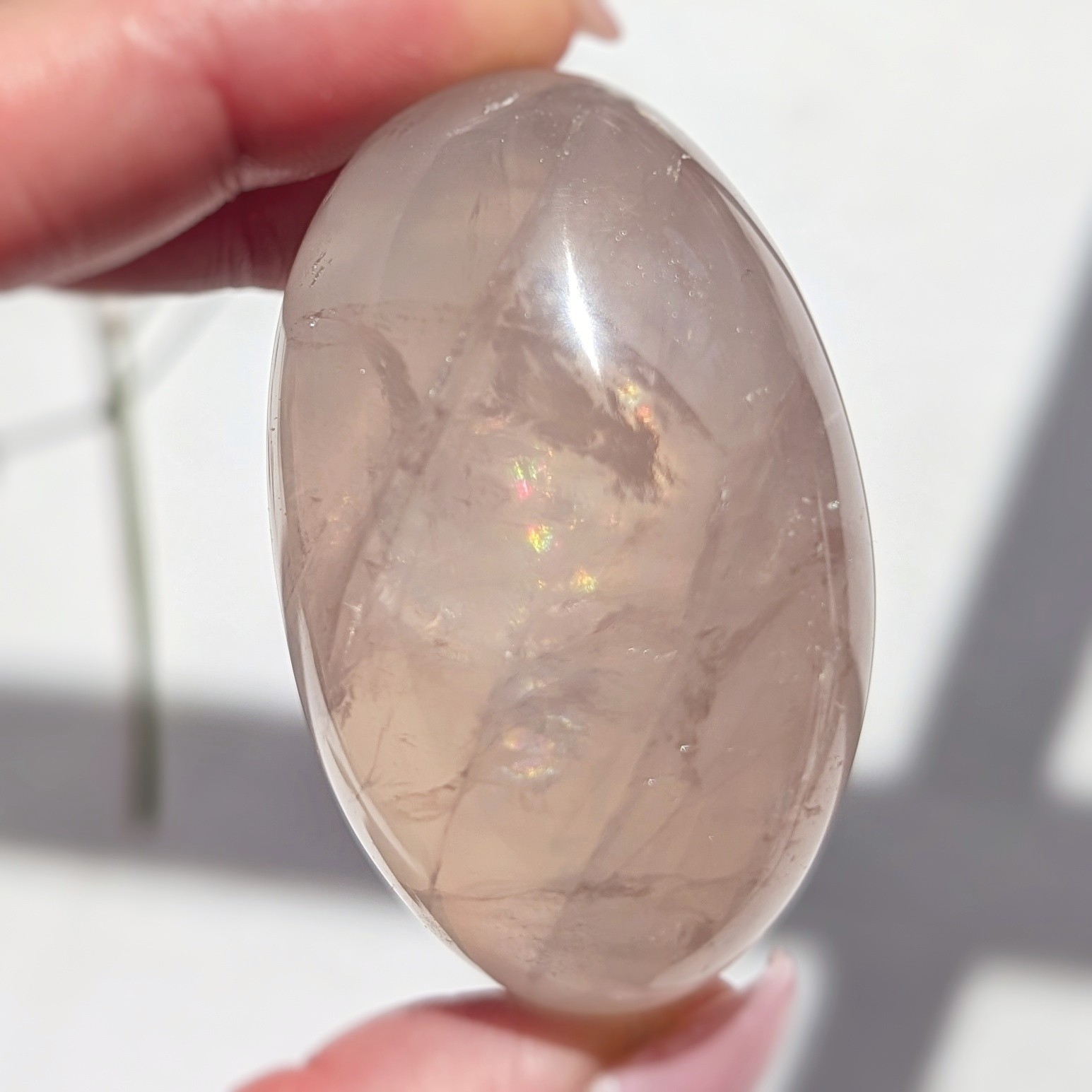 2″ translucent rose quartz palmstone with rainbow and asterism, star rose quartz