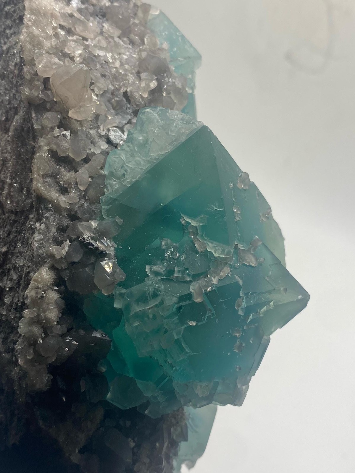 Teal Fluorite Octahedron Cluster on Smoky Quartz